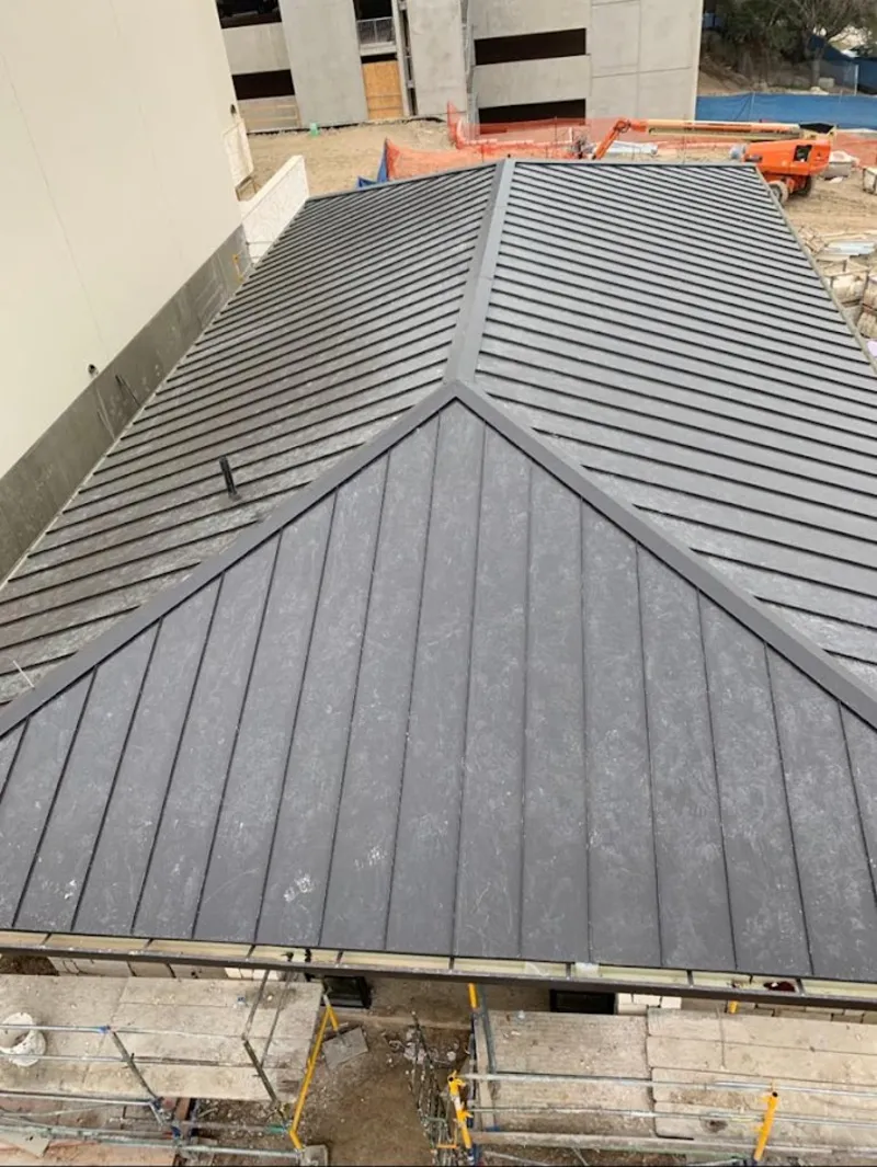 Commercial metal roof construction with crane equipment in Oronoko